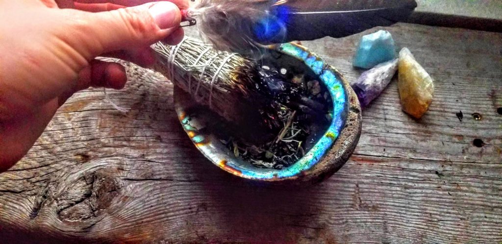 Hand made smoke bundle, and gifted sacred feathers that I work with in my smoke ceremonies.  The plant in this bundle is Mugwort, grown here at the farm to work with my dreamscapes.  - Cultural Appropriation in Smoke Medicine